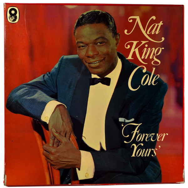 A picture of Nat King Cole in a Tux with a red velvet background