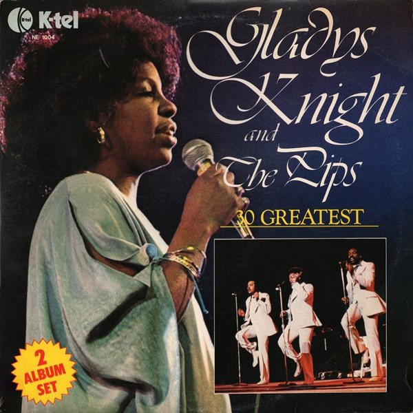 Gladys Knight Singing into a Microphone With The Pips in The Background