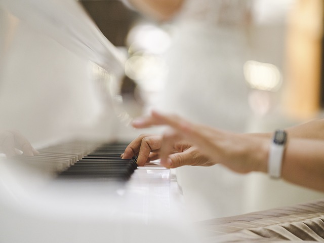 pianist at a white piano keyboard