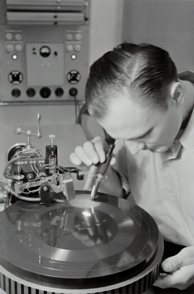 A sound engineer checking a vinyl record for quality
